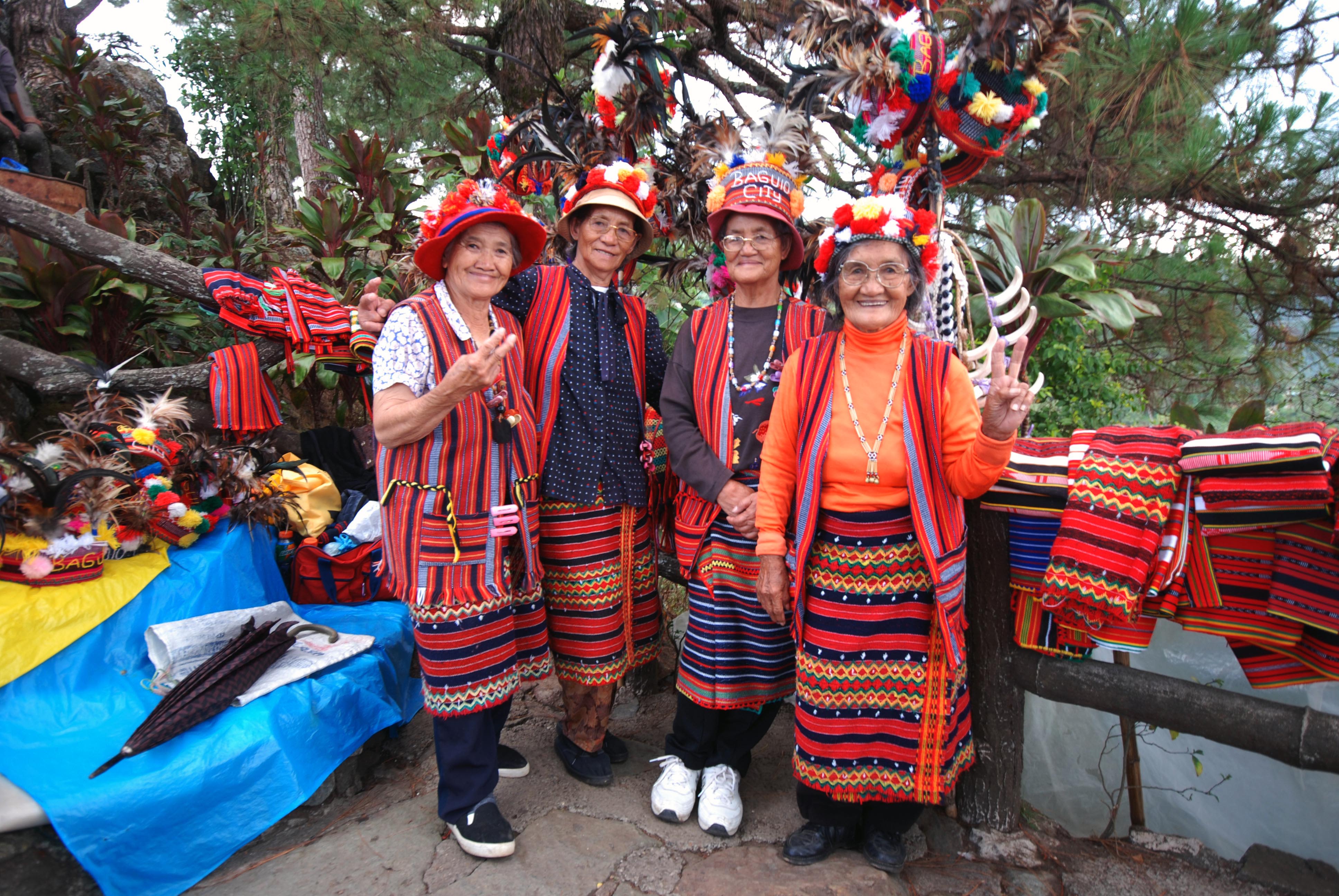 Group photo of Indigenous women from Northern Luzon, showcasing their weaved products