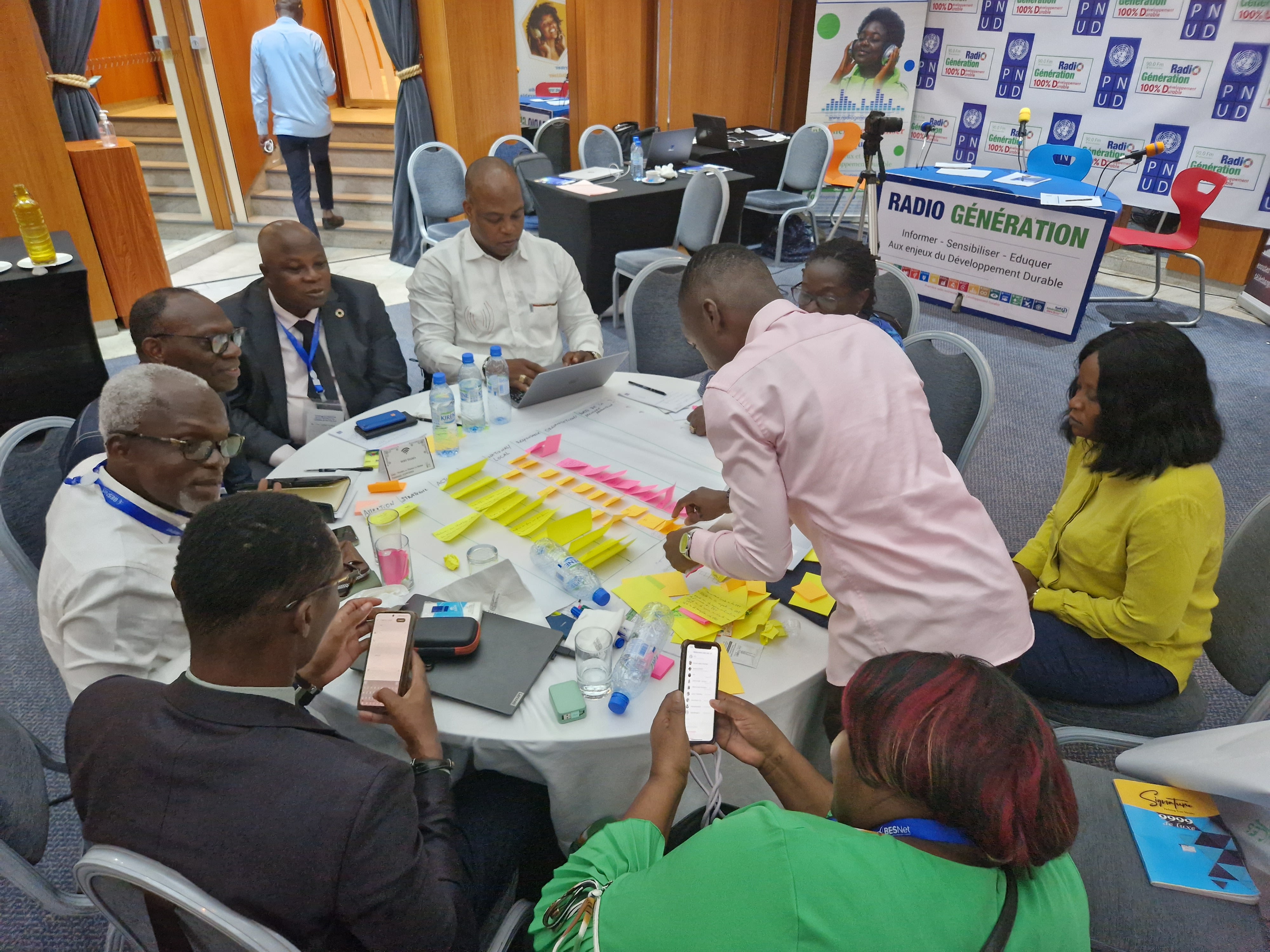 A group of people engaged in a collaborative discussion at the West and Central Africa Regional Trialogue event. 
