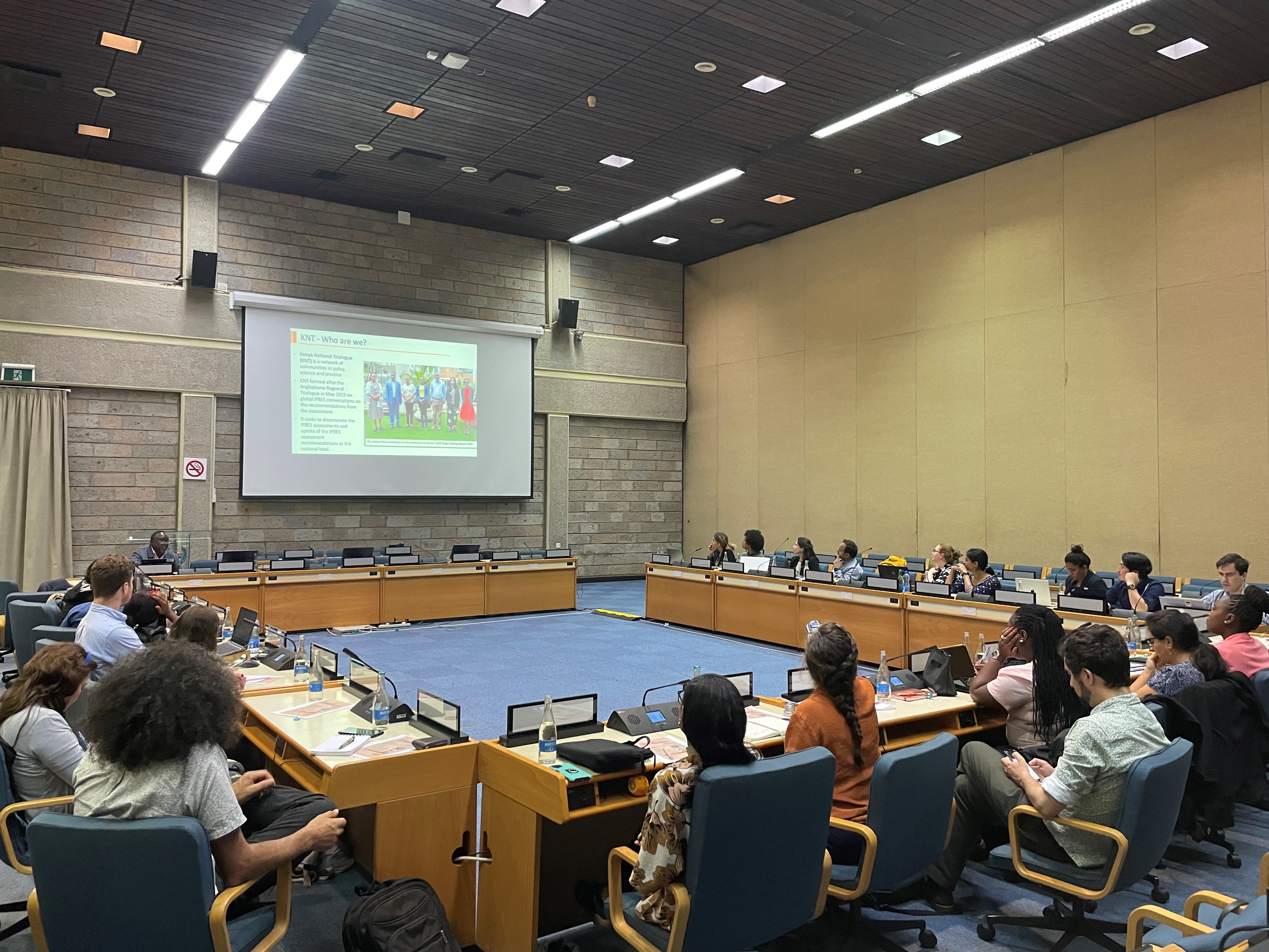 Participants of the IPBES Fellows Annual Training Workshop & Capacity-Building Forum gathered in a conference room