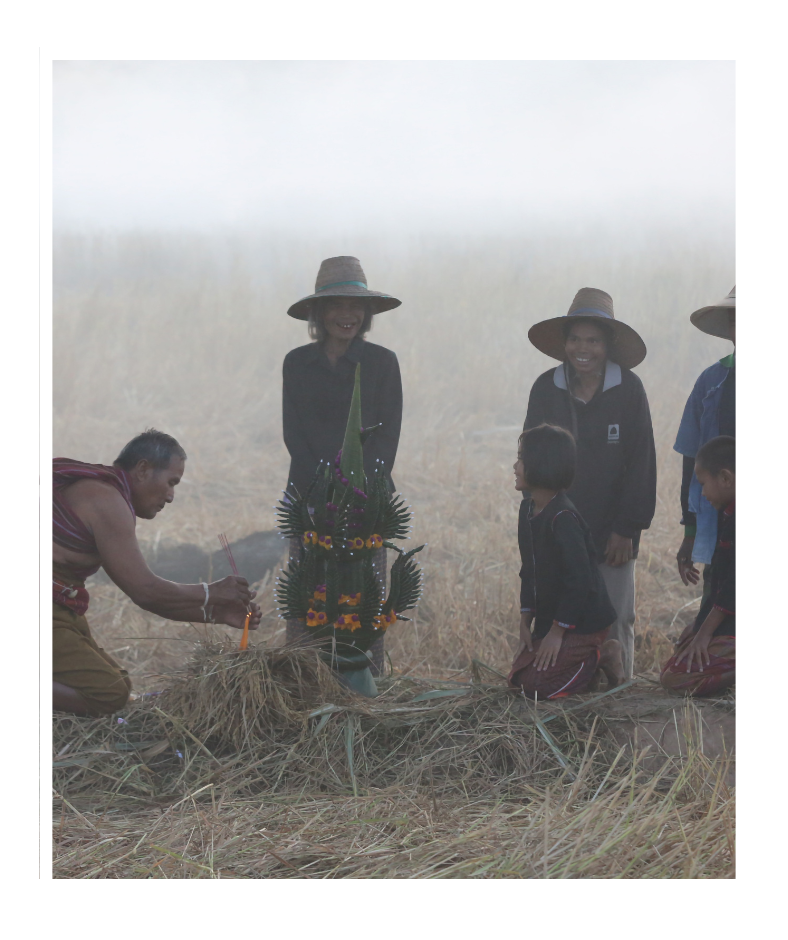 Indigenous people performing a ritual in the rice field
