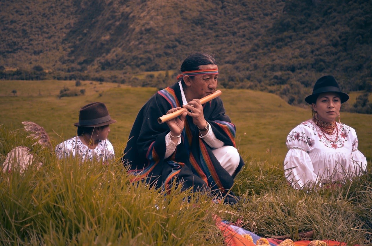 Indigenous person playing a mouth flute