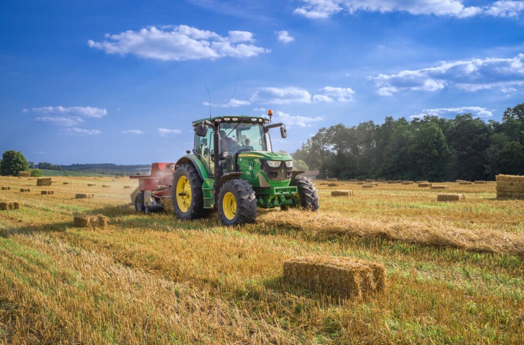 Photo of a tractor working in a wheat field.