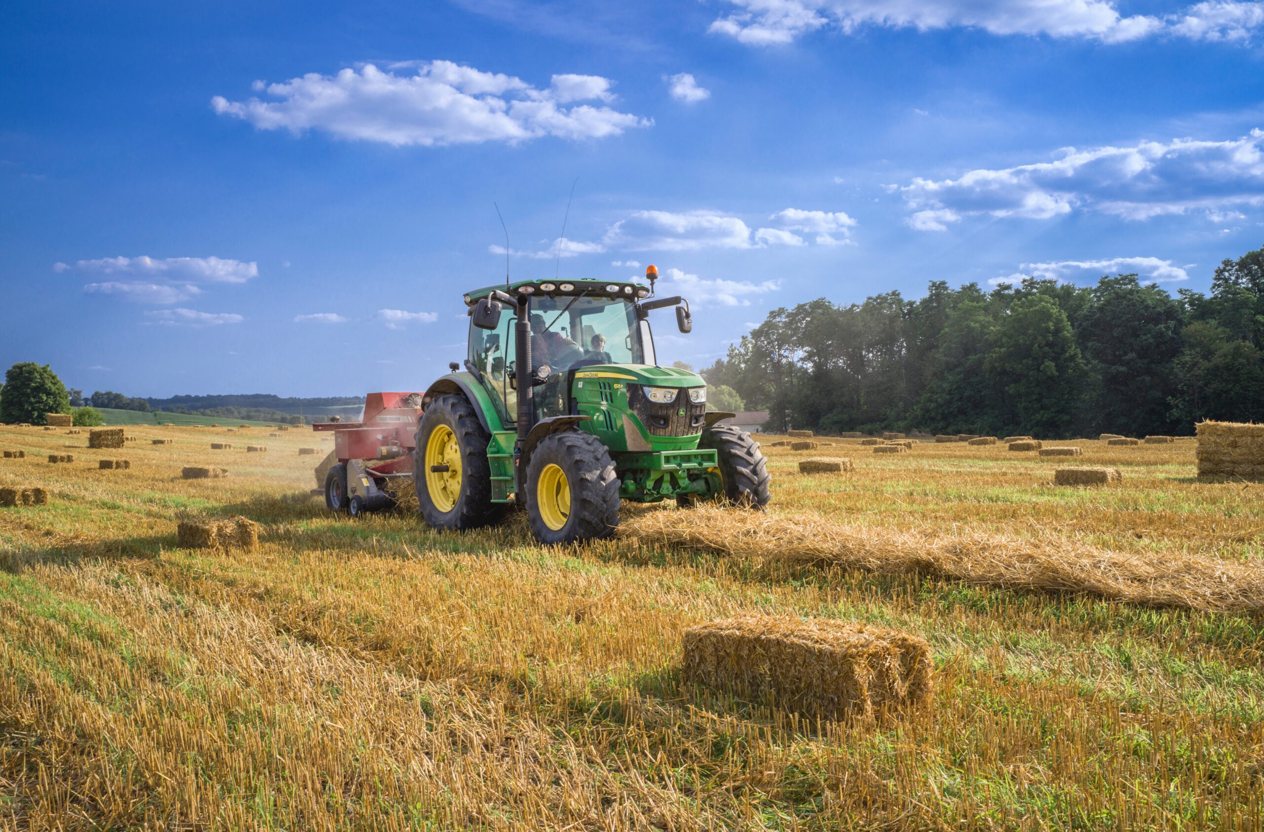 Photo of a tractor working in a wheat field.