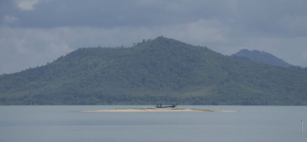 Thai fisherfolks rowing a boat