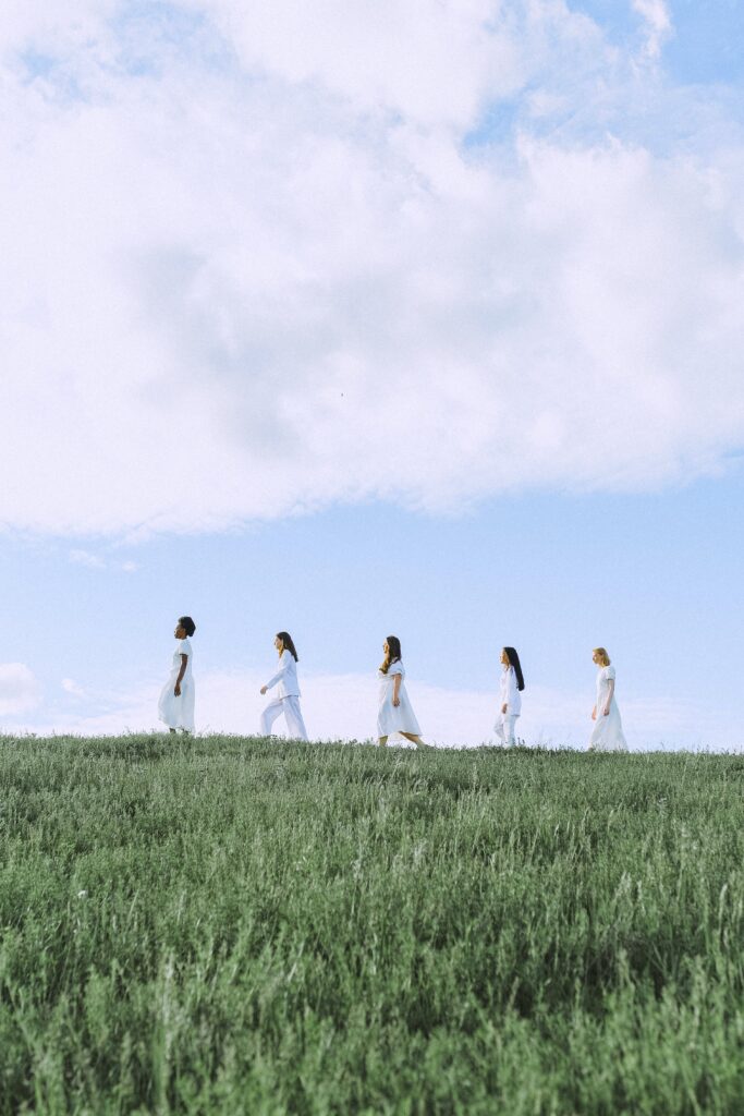 Photo of women walking on a grassland