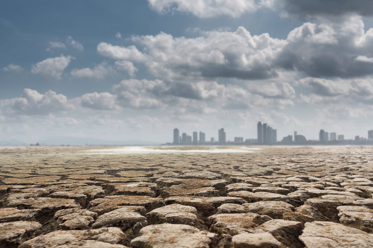 Photo by Kritsada Seekham: https://www.pexels.com/photo/dry-ground-with-megalopolis-on-background-7836300/